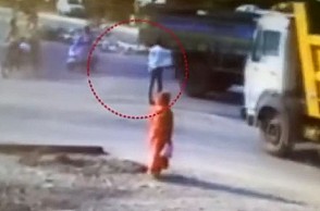 Watch video of man walking away after hit by speeding truck